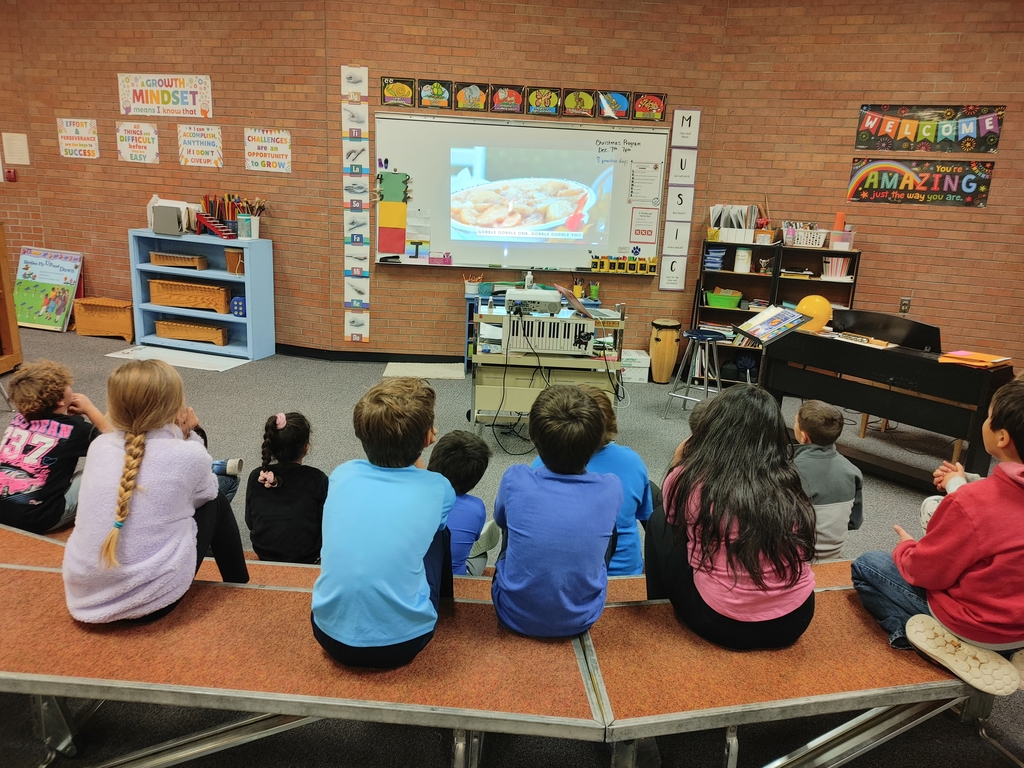 Students sitting and watching a music video.