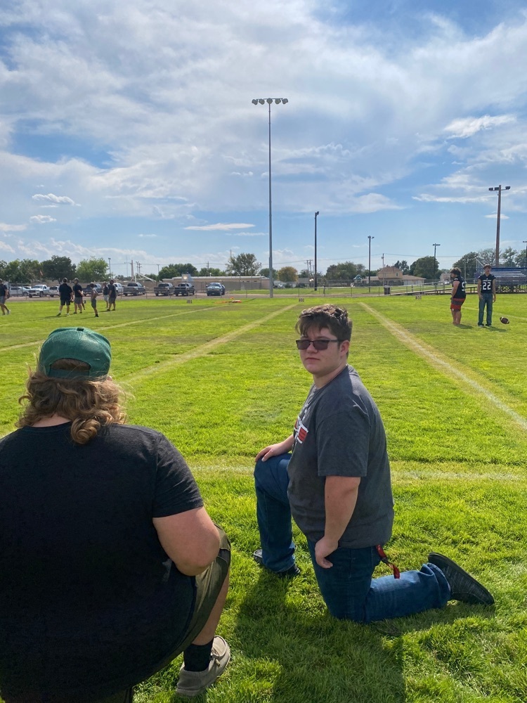 a student poses for the photo on the football field