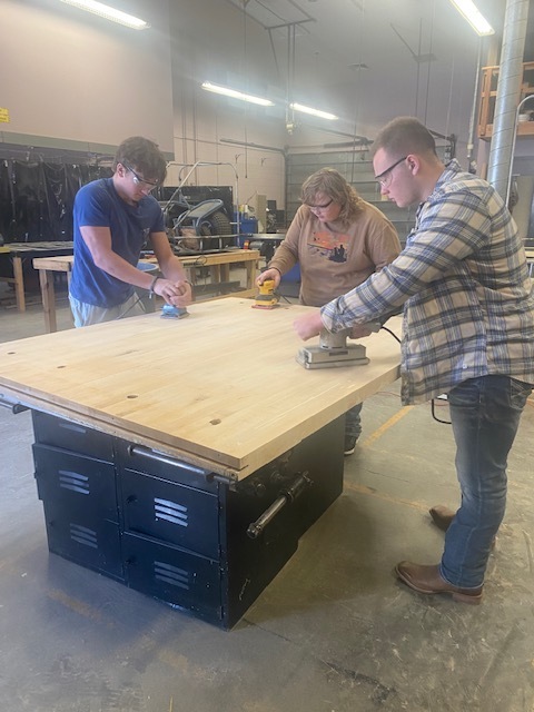 JHS students in Ag Mechanics work on the various steps of refurbishing the work benches that are located in the shop.  Hours of sanding is required before they can move forward. Upon further findings it appears the work benches were built out of the original gym floor from the high school.  Once refinished these work benches will be moved to the CTE area of the new Julesburg School District.
